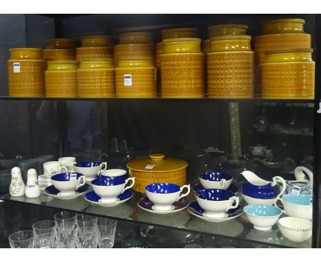 A collection of 14 Hornsea Saffron pattern kitchen storage jars, of retro orange and yellow flowerhead design with wooden lid