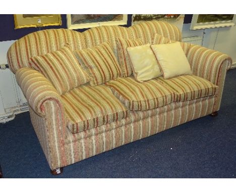 A vintage three seater sofa, upholstered in later beige striped fabric, 88cm high x 185cm wide