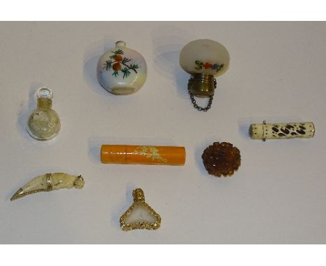 A small group of perfume vials, of differing designs, to include floral opaque glass bulbous bottle, carved amber, painted ce
