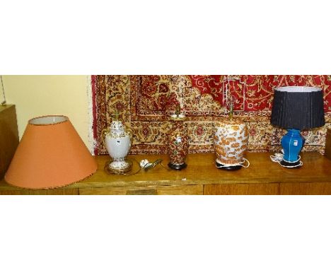 Four assorted ceramic table lamps, to include two in the Chinese style with shades, all raised on hardwood stands (4)