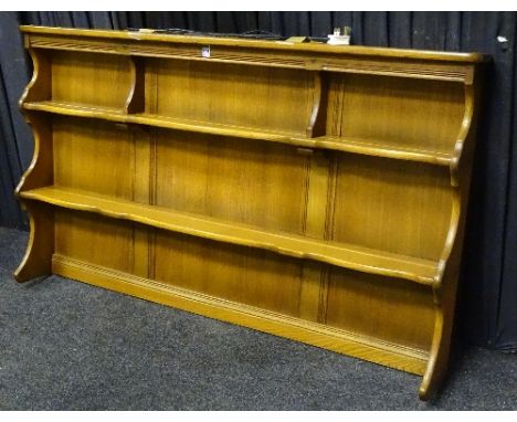 An Ercol Windsor style elm plate rack, with open shelving, fitted for electricity, 80cm high x 123cm wide