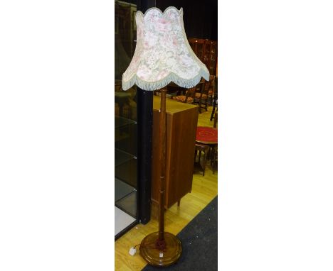A vintage oak floor lamp with shade, fitted for electricity, 150cm high 