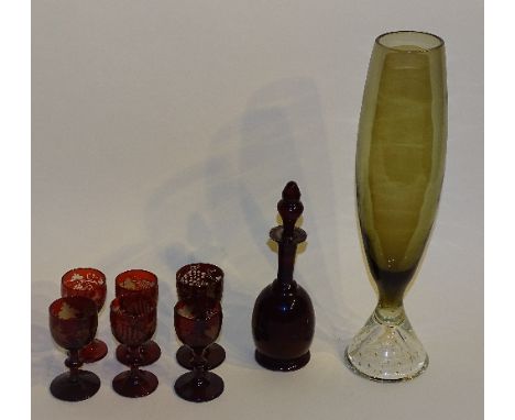 An antique ruby glass seven piece liqueur set, comprising of decanter with stopper and six glasses, 21cm high, together with 