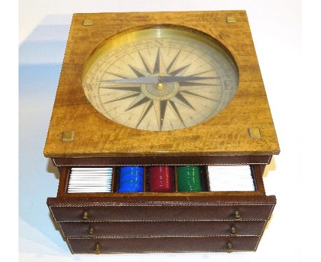 A vintage walnut cased games/roulette compendium, with glazed 9.5 inch compass dial to the top above three drawers enclosing 