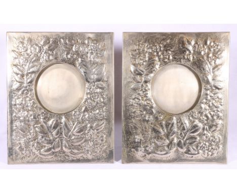 Pair of pewter easel picture frames with foliate decoration, 33cm
