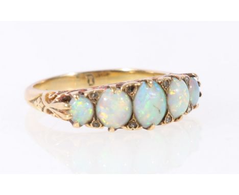 Edwardian five stone opal ring with diamond points in scroll setting, "18", size N. CONDITION REPORT: Opals intact but scratc