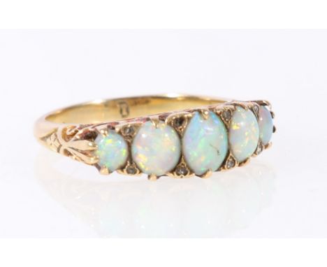 Edwardian five stone opal ring with diamond points in scroll setting, "18", size N. CONDITION REPORT: Opals intact but scratc