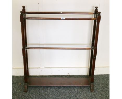 Mahogany towel rail block and tiered support mounted by finial, united by undertier, down swept feet, 69x84cm.