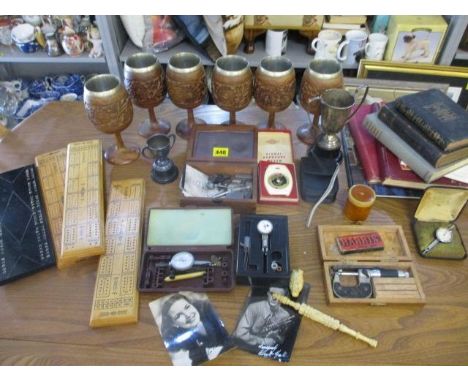 A vintage lot to include carved wooden wine goblets,  mixed books, various gauges, a digital camera, a small trophy and a cla