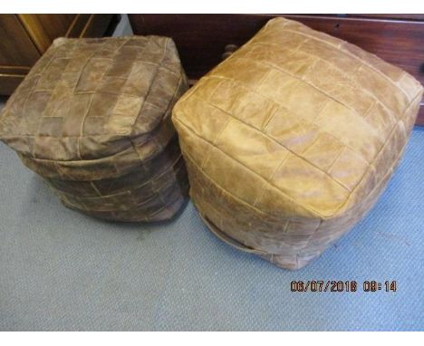 A pair of brown leather patch upholstered pouffes 