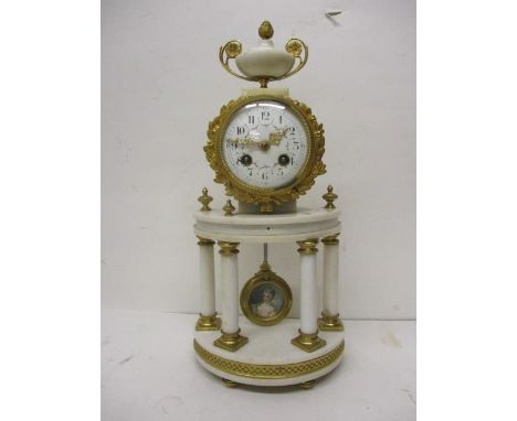 An early 20th century white marble and gilt brass mantle clock, having an urn over a drum design case, decorated with a wreat