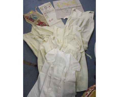 Three vintage tapestry and needlework panels, together with six childrens aprons 