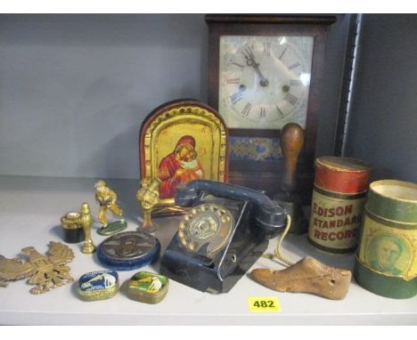 A vintage lot to include a child's telephone, a brass handbell and a mantle clock 