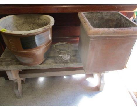 A pair of modern stone planters, a rustic garden bench and a wirework planter 