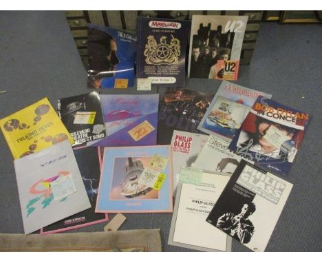 A collection of concert programs and their respective entry tickets to include 1985 Dire Straits, Philip Glass, Bob Dylan, Ma