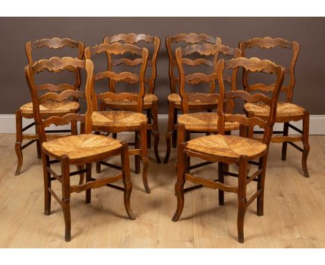 A set of eight fruitwood farmhouse chairs with shaped ladder backs and wicker seats41.5cm wide x 90.5cm highQty: 8Three with 