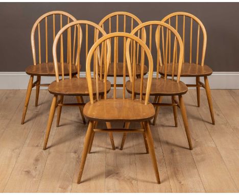 A set of six Ercol dining chairs with hooped backs above elm seats and outsplayed legs, united by H framed stretchers41cm wid