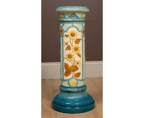 A mid-20th century Majolica Burmantofts jardinière stand, the body decorated with moulded sunflower decorations within arched