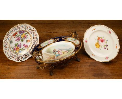 A Meissen porcelain plate with floral decoration and pierced border; a Sèvres style oval dish with painted decoration of two 