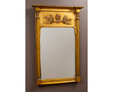An 18th century French Empire style gilt mirror, the frieze with a moulded mask and leaf decorations with pilasters surmounte