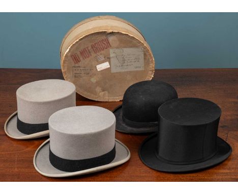 A collection of four hats to include three top hats, two of which are in grey felt and both retailed by Moss Bros of Covent G