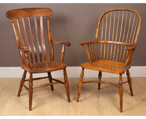 Two chairs, the first a yew wood Windsor chair with turned legs united by a crinoline stretcher; the second a comb back Grand