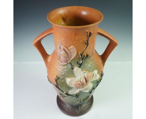 Large art pottery vase by Roseville in the Magnolia pattern, shape number 98-15. This classic two-handled form features raise