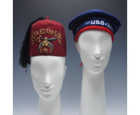 A distinctive duo of headwear including a 2002 U.S. Olympic Team beret by Roots and a Shriner fraternal fez. The Olympic bere