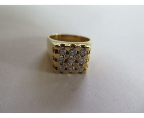 An 18ct yellow gold ladies or gents diamond ring set with thirteen stones, nine of approx nine points and four of approx thre