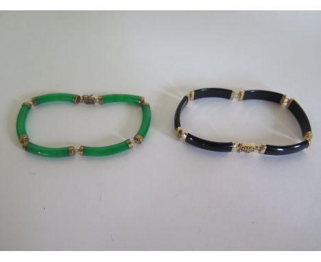 A nephrite jade bracelet with 14ct gold links and clasp together with another in jet, each bracelet approximately 18.5cm long