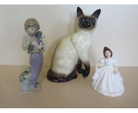 A Beswick cat together with a Lladro figurine a boy holding a puppy and a Royal Dolton figurine entitles Amanda which comes w