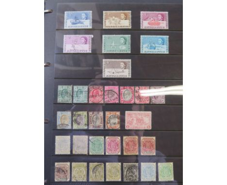 Three stamp albums, one of International stamps including some from  Australia, New Zealand, Uganda and Kenya two of British 