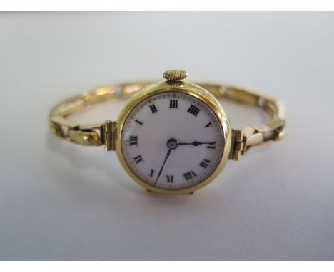 A ladies wristwatch with an 18ct gold case and a sprung 15ct gold bracelet, also featuring  Roman numeral dial, approximately