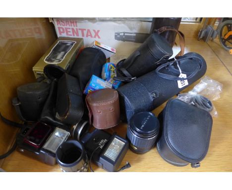 A collection of nine various camera lenses and accessories, including an Asahi 1:4.5 85 - 210mm, a Sunagor Maxima 35-200mm F3