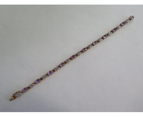 A 9ct yellow gold Amethyst and diamond bracelet - 18cm long - marked 375 DIA - in good condition - approx 9.2 grams 