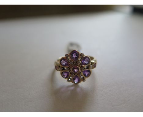 A hallmarked 9ct yellow gold amethyst and seed pearl cluster ring, size O - approx 2.8 grams - ex jewellers stock, new condit