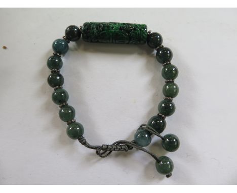 A well carved Chinese jade bracelet, centre piece 3cm x 0.8cm, in very good condition 