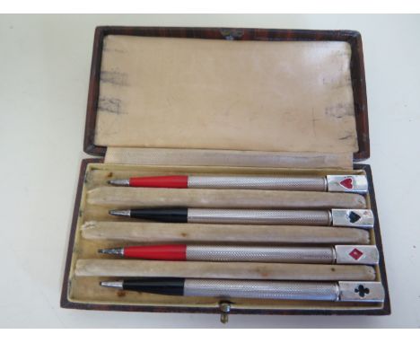 A set of four silver bridge pencils with enamel decoration, 10cm long, some minor enamel loss, otherwise good 