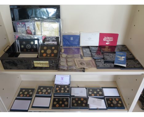 A collection of 29 British proof coins sets and commemorative coins with a tin trunk 