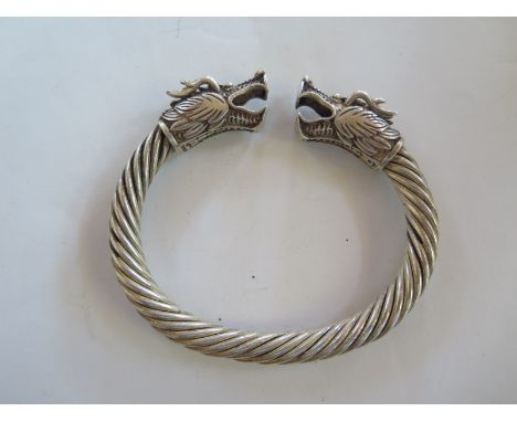 An oriental white metal dragon bangle - 10cm wide 