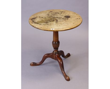 A mahogany tripod table with a circular top, &amp; on a carved vase-turned centre column &amp; three cabriole legs with pad f