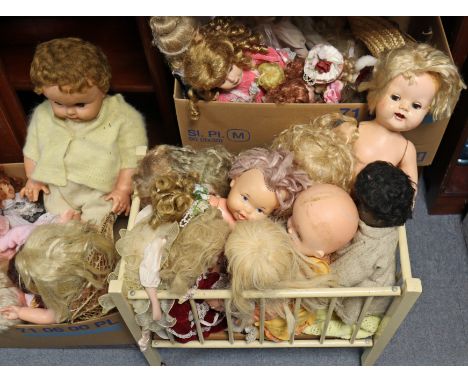 A collection of approximately forty various dolls; &amp; a painted wooden dolls cot. 
