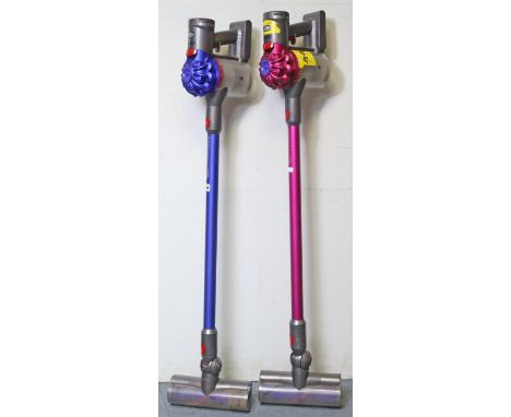 Two Dyson “V7 Motorhead” stick vacuum cleaners, with various accessories.