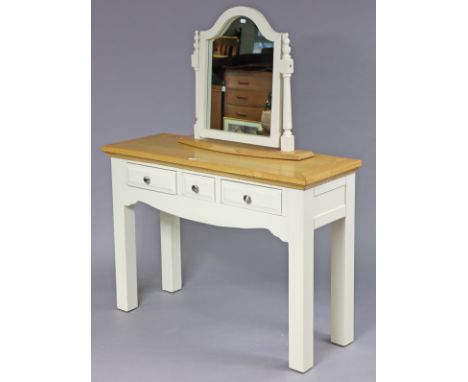 A light oak &amp; white finish dressing table fitted three frieze drawers &amp; on square legs, 110cm wide x 78cm high x 40cm