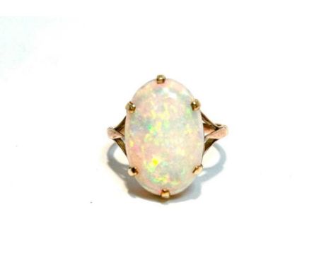 An opal ring, the oval opal cabochon measuring approximately 17 x 11mm, in gold mount, unmarked, tests as approximately 9ct g