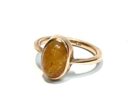 A yellow stone cabochon ring, the oval cabouchon possibly golden jade, in gold mount and shank, stamped '15', ring size P, 4.