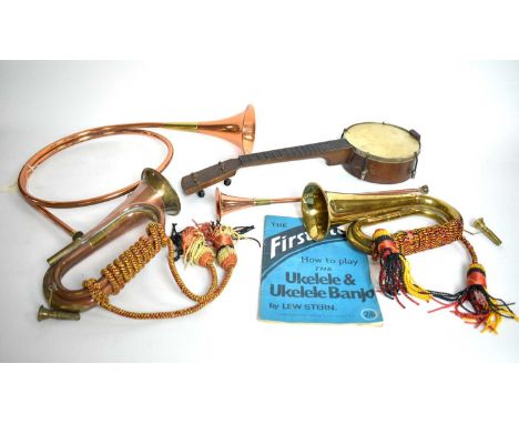 A selection of vintage musical instruments, comprising: a brass bugle; a copper and brass bugle; two copper and brass hunting