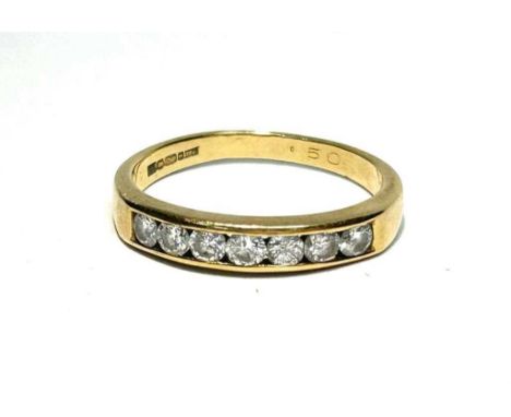 A seven stone diamond ring, the brilliant cut diamond weighing approximately 0.54ct in channel setting on 18ct yellow gold sh