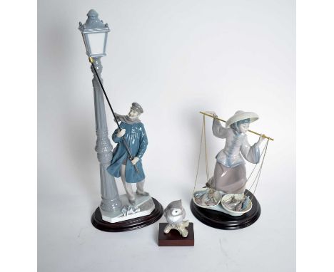 A Lladro figure of a Lamp Lighter; together with a Lladro figure of ‘Fish a Plenty’ or ‘Chinita en el Mercado’; and a Lladro 