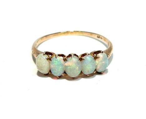 An opal ring, the five oval opal cabochons in 9ct yellow gold mount and shank, ring size S, 2.1g gross.